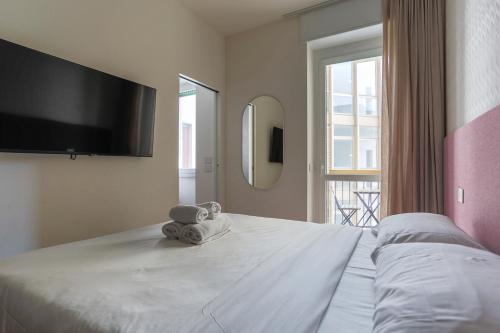 a bedroom with a large bed with a tv on the wall at YLS Luxury Suites 2 in Milan