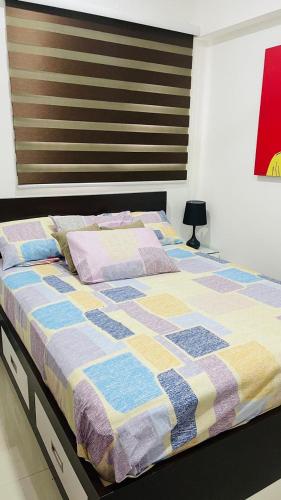 a bed with a quilt on it in a bedroom at Oval View Residence by C in Colombo