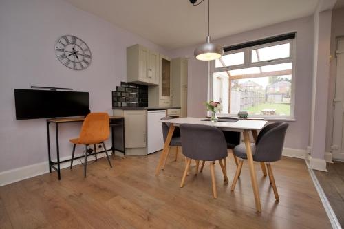 a kitchen and dining room with a table and chairs at London Road Villa - Free Netflix, Private Parking, WiFi & Private Garden in Coventry