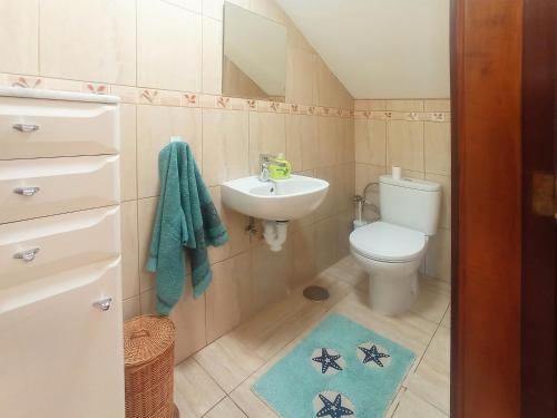 a small bathroom with a toilet and a sink at Los Azahares Apartment in Costa Del Silencio