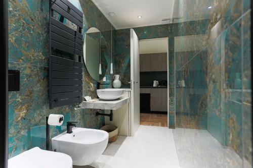 a bathroom with a sink and a toilet and a mirror at YLS Luxury Suites 2 in Milan