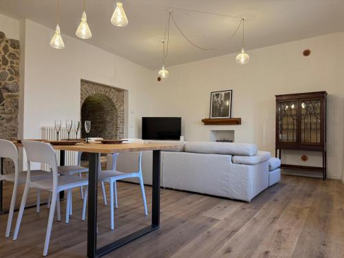 a living room with a table and a couch at Sara Home in Guarene