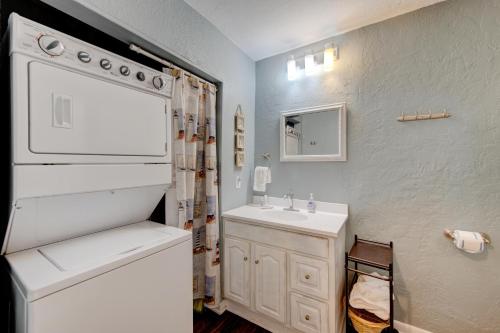 a bathroom with a sink and a toilet and a mirror at Beach Bum Headquarters in Mustang Beach