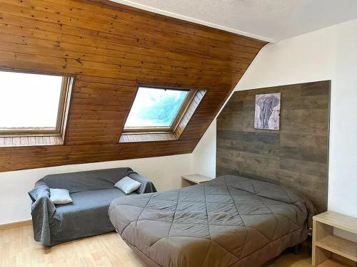a bedroom with a bed in a room with wooden ceilings at Apartamentos Solaris 3000 in Pas de la Casa