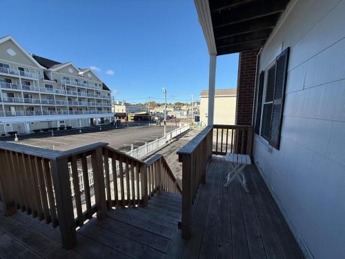 a wooden deck with a bench on a building at Aqua Amour Studio in Old Orchard Beach
