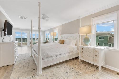 a white bedroom with a bed and a window at GP57: 57 Grand Pavilion in Isle of Palms
