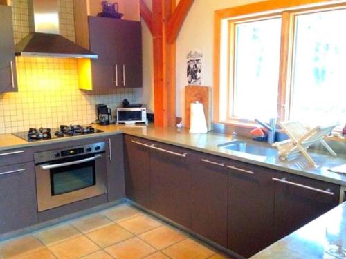 a kitchen with a sink and a stove top oven at Beautiful Two-Bedroom Cabin Rental Set in the Forests of the Berkshires, Massachusetts in Worthington Center