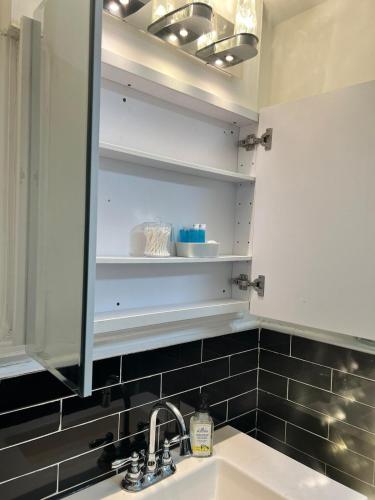 a bathroom with a sink and a mirror at New 3 BR Apt in Elizabeth Railroad Style Path Train Bus Hospital EWR Airport NJ Manhattan NYC in Elizabeth