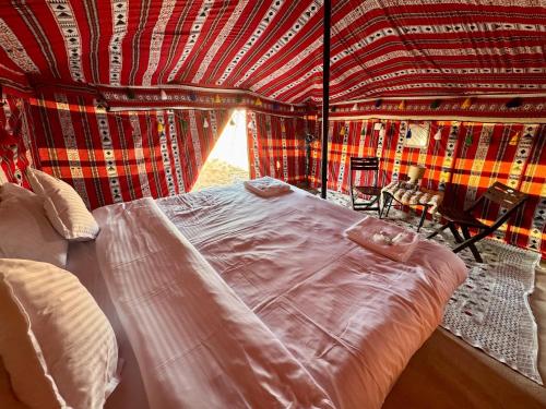 a bedroom with a bed in a tent at layali camp in Bidiyah