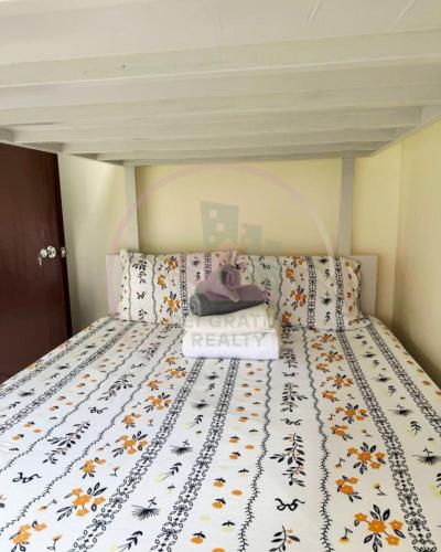 a bed with a purse sitting on top of it at Burnham Hill 504 Baguio Condo by Dei Gratia in Baguio