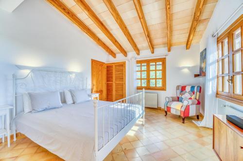a bedroom with a bed and a chair at Villa Morea in Manacor