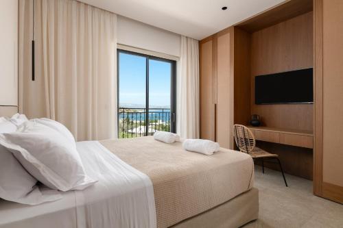 a bedroom with a large bed with a large window at Villa Celestia in vlicha