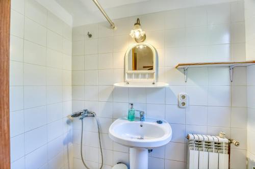 a white bathroom with a sink and a mirror at Villa Morea in Manacor