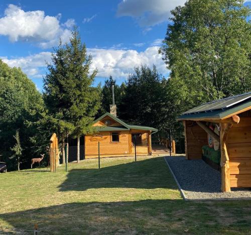 a log cabin with a gazebo and a house at Cicha Strzała 