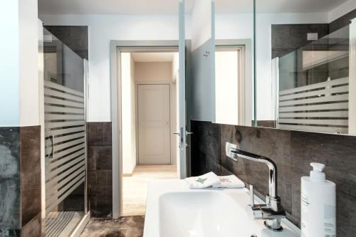 a bathroom with a sink and a mirror at Residenza di Luce - by MyHomeInComo in Griante Cadenabbia