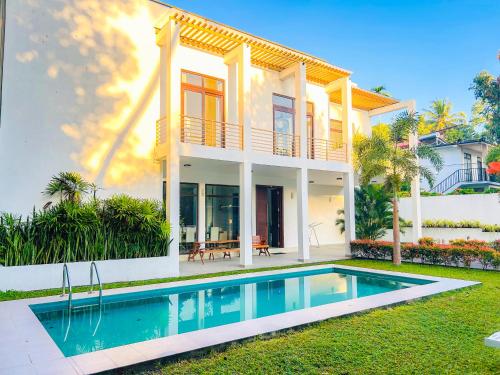 a house with a swimming pool in front of it at Trident Kandy in Kandy