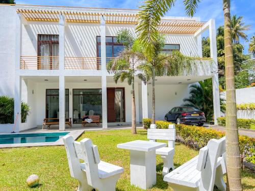 a villa with a pool and a house at Trident Kandy in Kandy