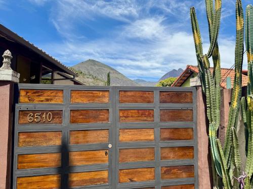 a wooden garage door with a cactus at Casa com piscina em Nogueira - 6 pessoas in Araras Petropolis