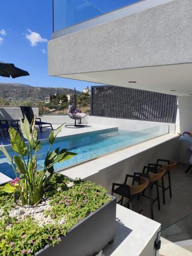 an image of a house with a swimming pool at Αriadne in Porto Rafti