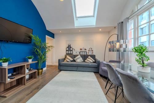 een woonkamer met een bank en een tv bij Berwick Soho Suites by Aureva Residences in Londen