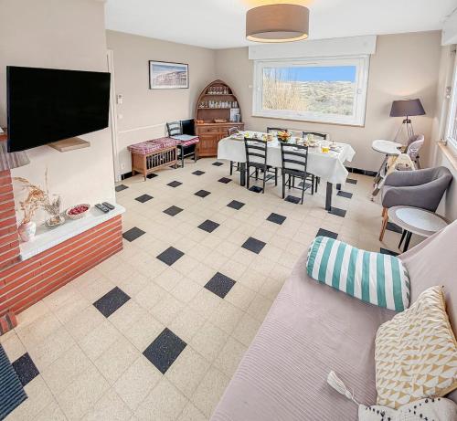 a living room with a couch and a table at Marluis Mer - Apartment near dunes and beach in Cucq