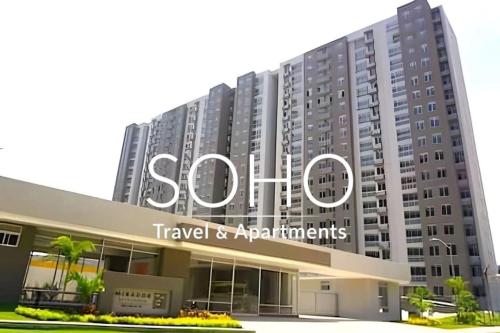 a large building with a sign that reads shuttle travel and apartments at Mirador Apartments – Excellent Location by SOHO in Barranquilla