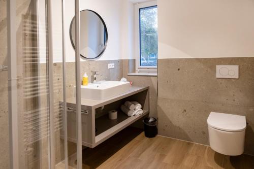 a bathroom with a sink and a mirror at Gasthof Garni Knupfer in Ehingen