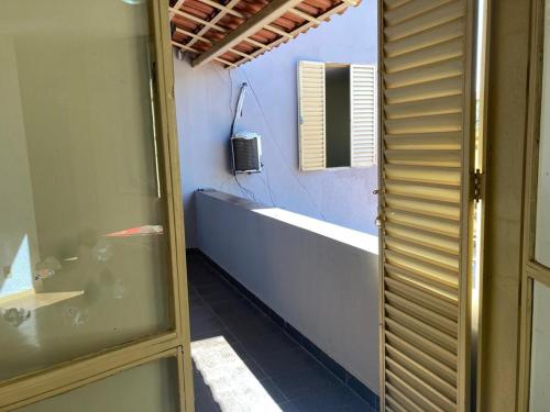 a bathroom with a bath tub and a sink at Solar dos Costais in Uberaba