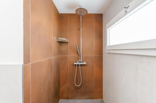 a bathroom with a shower with a shower head at Little Cottage near Ferrari's City in Montale