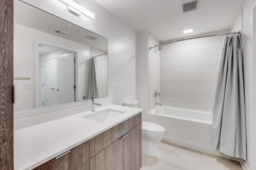 a bathroom with a sink and a tub and a toilet at Bluebird Suites at Capitol Hill in Washington
