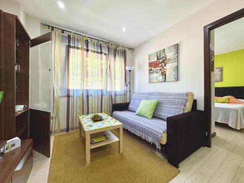 a living room with a couch and a table at Loft BAINIS Peregrinos & Uso Turístico in A Guarda