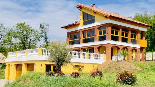a yellow house on top of a hill at VILLA BEELVITA - PRIVATE POOL& JACUZZi in Bielovce