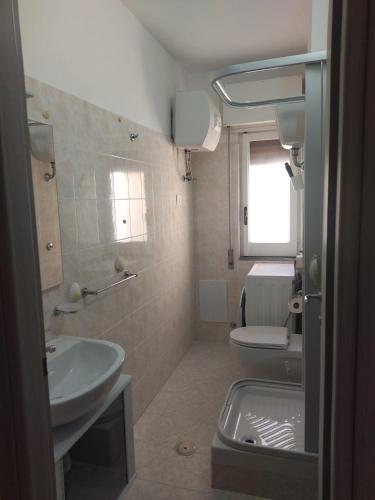 a bathroom with a sink and a toilet at Casa Vacanze Falco in Agropoli