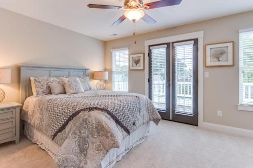 a bedroom with a bed and a ceiling fan at 404B The Princess Anne House in Virginia Beach