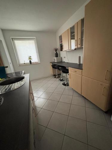 a kitchen with a counter and some tables in it at FEWO Caro in Nordhausen