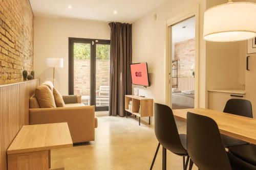 a living room with a table and a dining room at GuestReady - ARIQUS Apartments in Hospitalet de Llobregat