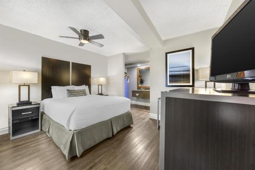 a bedroom with a bed and a flat screen tv at Best Western Pier Point Inn in Florence