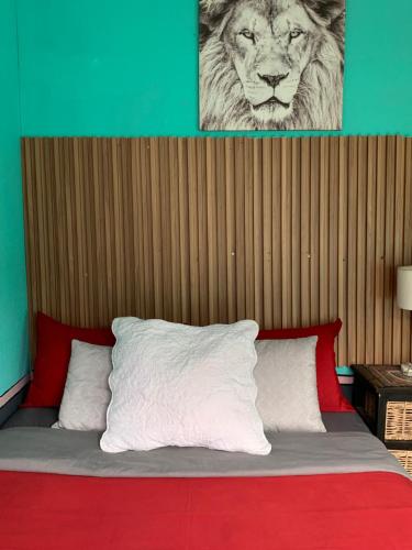 a bed with a lion picture on top of it at Ewakanda Backpackers in Vereeniging