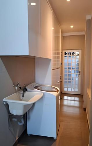 a bathroom with a sink and a white sink at Casa confortável com piscina e área para churrasco in Sao Jose do Rio Preto