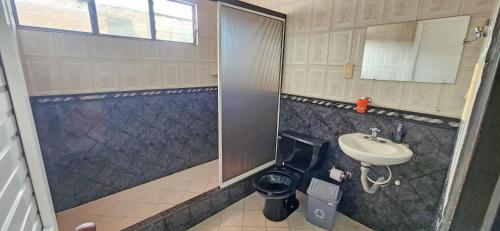 a bathroom with a toilet and a sink at Casa del Pino in Popayan