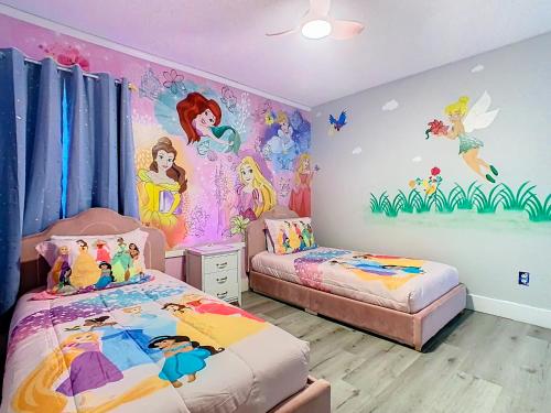 a childs bedroom with a disney princess wall mural at Casita mi Encanto a Cozy & Spacious House, 4-bedroom 3-Bath & pool in Kissimmee