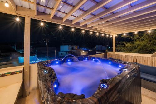 a large jacuzzi tub in a building with lights at 3 Story Home 3BR 2BA with Pool Garage and Rooftop View in La Choya