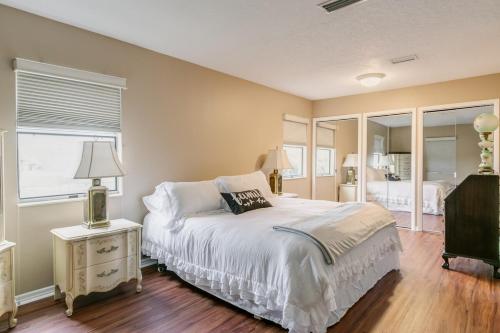 a bedroom with a white bed and a window at Welcome to Your Serene Waterfront Getaway! in Cocoa