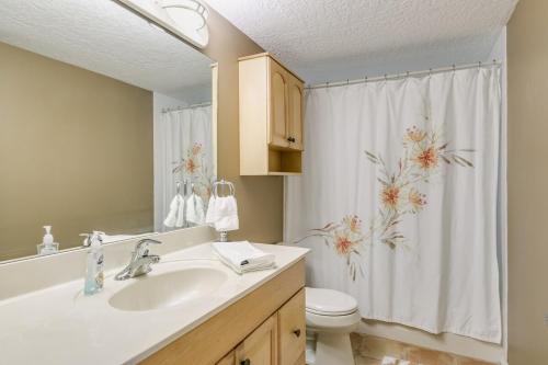 a bathroom with a sink and a toilet and a shower curtain at Welcome to Your Serene Waterfront Getaway! in Cocoa