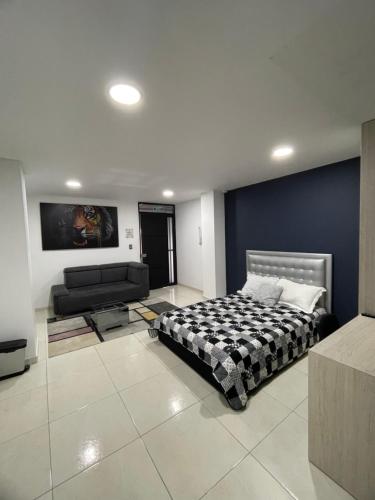 a large bedroom with a bed and a couch at Evo Deluxe Room l Santa Rosa de Cabal in Santa Rosa de Cabal