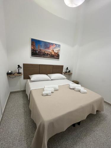 a bedroom with a large bed with towels on it at D'Aversa Rooms in Marineo