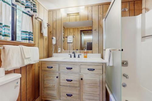 a bathroom with a sink and a mirror at Talmont Trailhead Cabin in Tahoe City