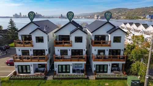 an aerial view of a large white house with balconies at Dragestil 713 Duluth Luxury Condos by Heirloom Boutique Collection in Duluth