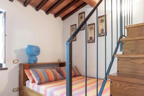 a bedroom with a bed and a stair case at Stone Villa Overlooking Panicale Vineyards in Panicale