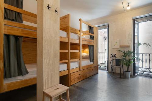a room with two bunk beds and a balcony at The Hat Madrid in Madrid